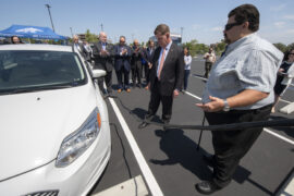 <p>Ronald Fleming, right, executive director of UCI Transportation &amp; Distribution Services, helps U.S. Secretary of Labor Marty Walsh connect an electric car with a campus charging station, with Chancellor Howard Gillman, UC Regent John A. Pérez, UCI Vice Chancellor for Research Pramod Khargonekar, U.S. Rep. Mike Levin and Irvine Mayor Farrah Khan looking on. Steve Zylius / UCI</p>
