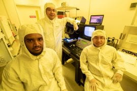 <p>Yonatan Gizachew Achamyeleh, UCI Ph.D. student in electrical engineering and computer science (left), Mohammad Al Faruque, UCI professor of electrical engineering and computer science (center), and Anomadarshi Barua, UCI Ph.D. candidate in electrical engineering and computer science (right), conducted part of their research project into a potential threat to negative pressure facilities in an actual clean room designed to prevent external exposure to dangerous microbes. Steve Zylius / UCI</p>

