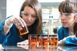 <p>Doctoral students Melissa Brock (left) and Joana Tavares compare ocean water samples collected in Huntington Beach after a massive oil spill. Photo by Steve Zylius/UCI</p>
