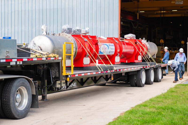 <p>This 13-meter-long assembly for the HL-LHC upgrade comprises two superconducting magnets. It was shipped from Fermilab to CERN. (Credit: Ryan Postel/Fermilab)</p>
