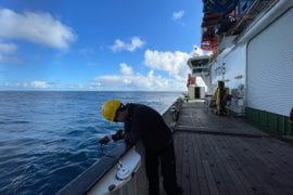 <p>Henri Drake, UC Irvine assistant professor of Earth system science, shown here aboard the U.K. research vessel RRS Discovery, used an acoustic transducer to locate moorings that he and his fellow scientists had anchored on the seafloor about a mile below the surface. The team worked to develop a better understanding of the way seawater upwells from dense, cold layers at the ocean’s bottom to upper strata. Bethan Wynne-Cattanach / Scripps Institution of Oceanography</p>
 