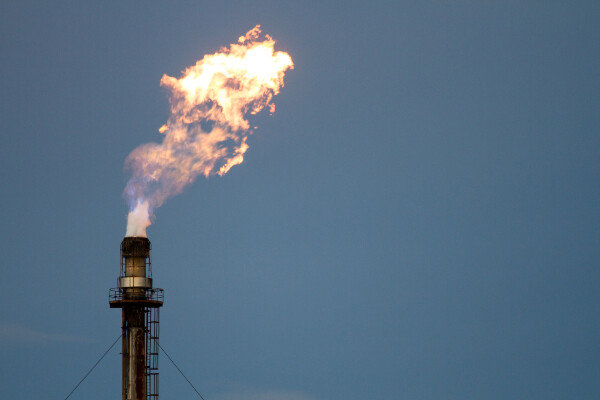 a methane flare against a blue sky