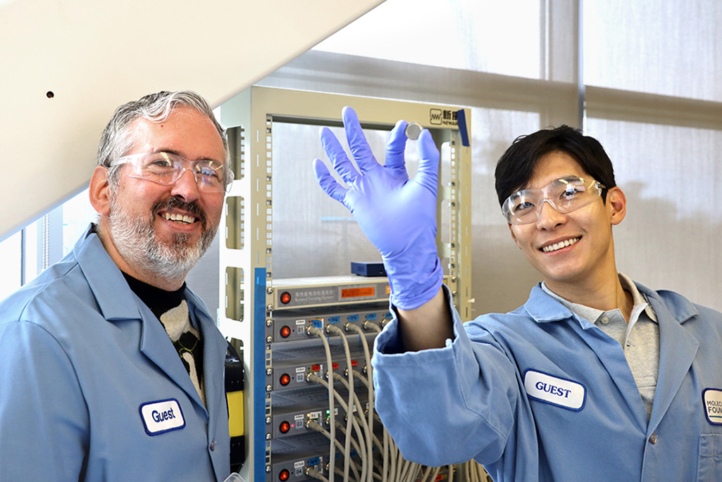 <p>Brett Helms, senior staff scientist at the Molecular Foundry, with Youngmin Ko, a postdoctoral researcher, who is holding a coin cell battery used in this research. (Credit: Jeremy Demarteau)</p>
