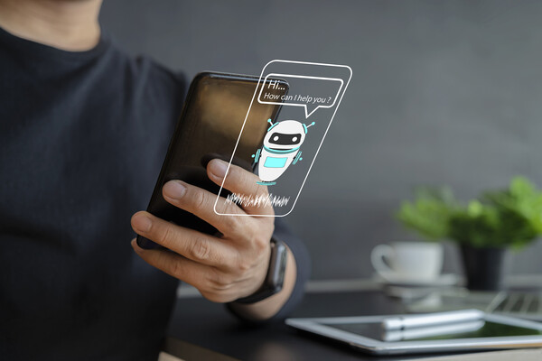 Person with smartphone engaging with chatbot.