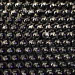 <p>Photo of a small section of the DESI focal plane, showing the one-of-a-kind robotic positioners. The optical fibers, which are installed in the robotic positioners, are backlit with blue light in this image. (Credit: DESI collaboration)</p>
