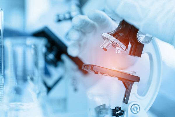 Closeup of a microscope in a lab.